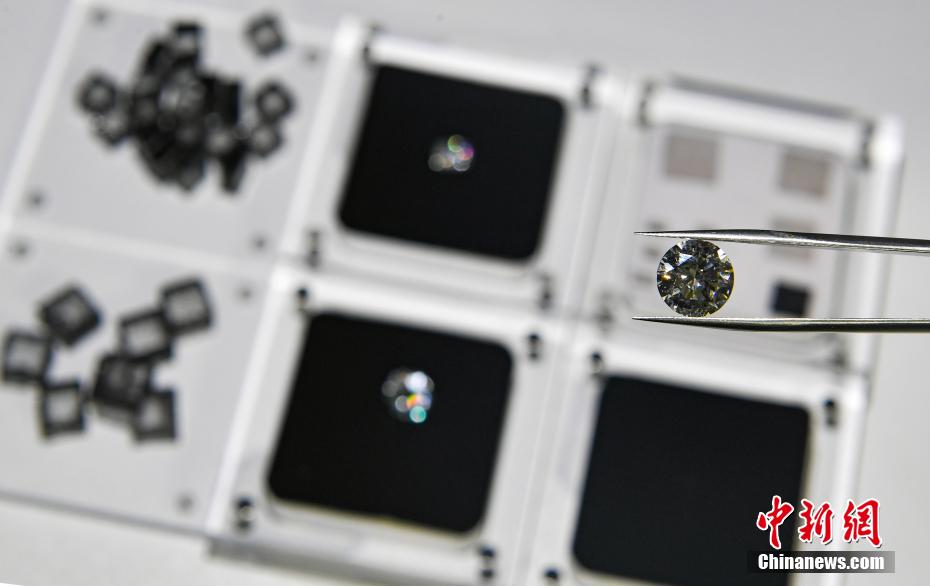 资料图:工作人员展示一颗4克拉的人工钻石。 韩苏原 摄