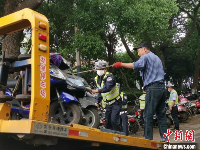 对违法占道停放的非机动车进行现场拖车 唐娟 摄