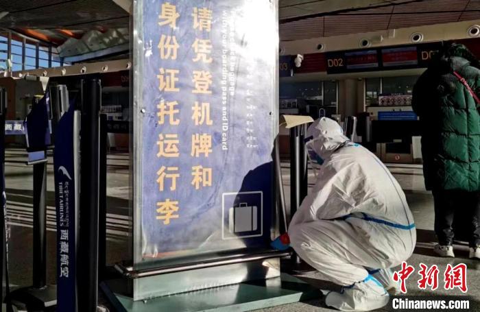 12月8日,拉萨贡嘎机场已恢复自助值机,工作人员正在安装告示牌。 李鸥 摄