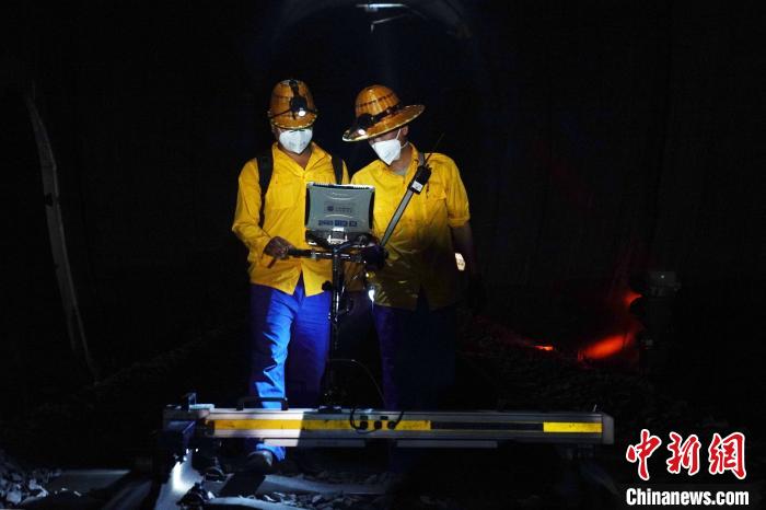 图为线路工推着轨检小车巡查铁路。 吴宇 摄